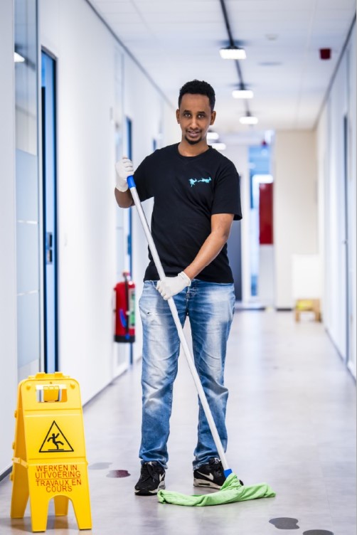 cleaning in schools - cleaner - corridor - mopping - safety sign - Cleaning Masters - Multi Masters Group